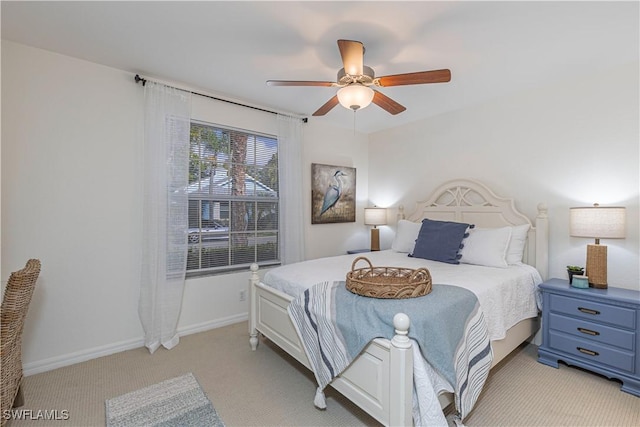 bedroom featuring light carpet, ceiling fan, and baseboards