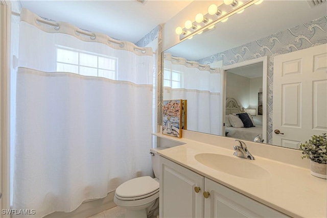 ensuite bathroom with toilet, connected bathroom, shower / tub combo, wallpapered walls, and vanity