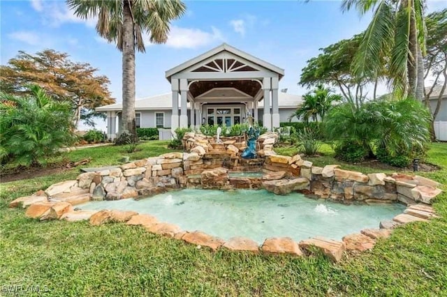 rear view of house with a jacuzzi