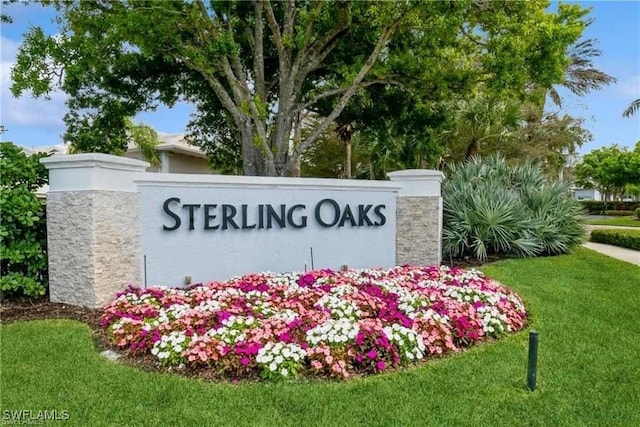 community sign featuring a lawn