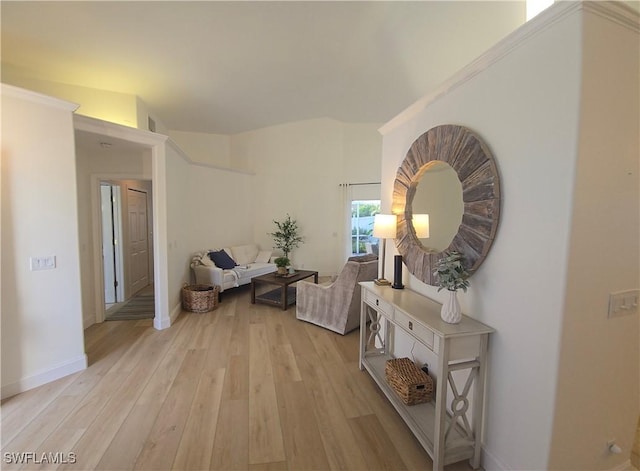 hallway featuring baseboards and light wood-style floors