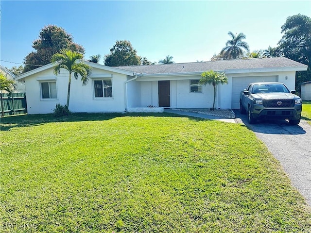 single story home featuring a garage and a front lawn