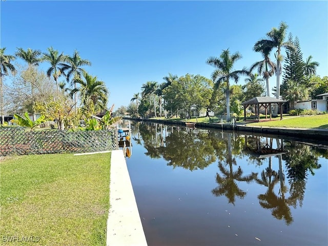 dock area featuring a water view and a lawn