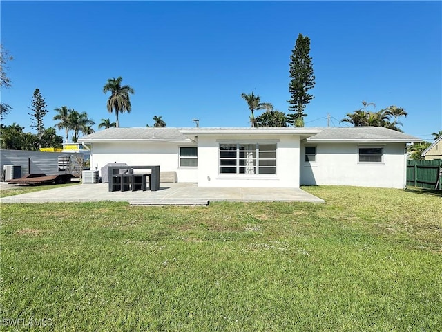 rear view of property with central AC unit, a yard, and a patio