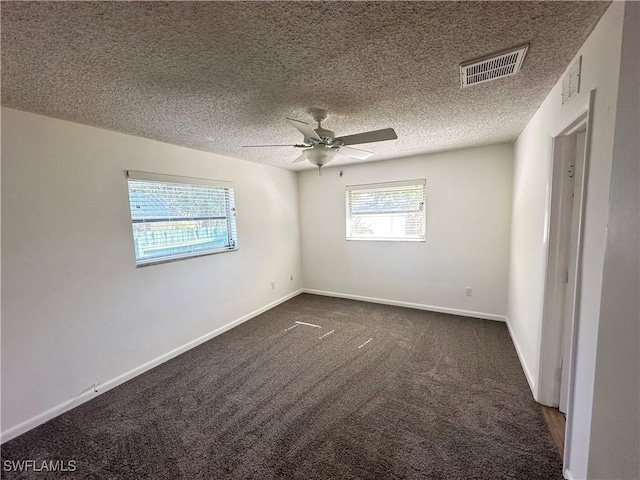 carpeted empty room with ceiling fan and a textured ceiling