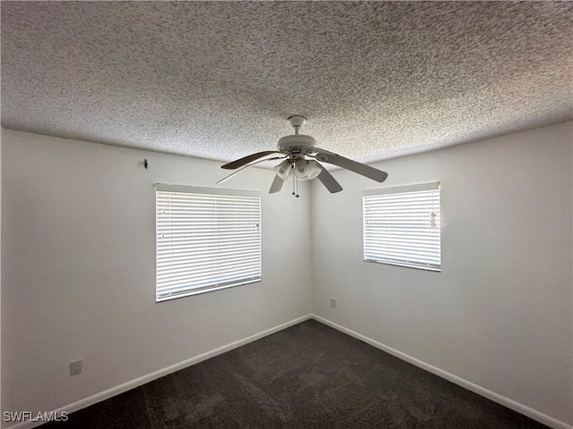 carpeted spare room featuring ceiling fan and a textured ceiling