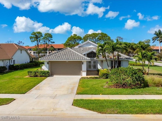 view of front of property with a garage and a front lawn