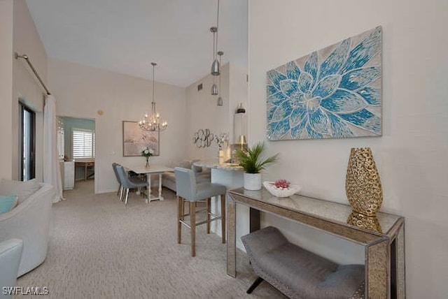 carpeted dining space featuring high vaulted ceiling and a notable chandelier