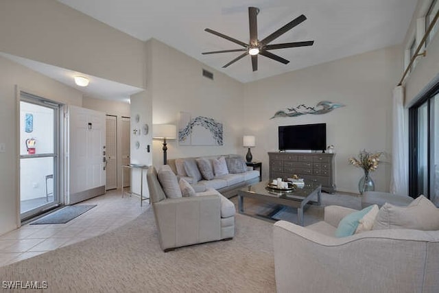 living room with a high ceiling, light tile patterned floors, and ceiling fan