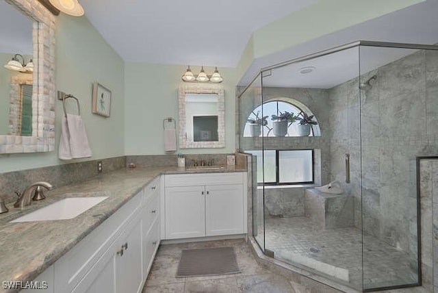 bathroom featuring walk in shower and vanity