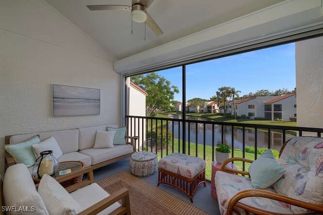 sunroom with vaulted ceiling, a water view, and ceiling fan