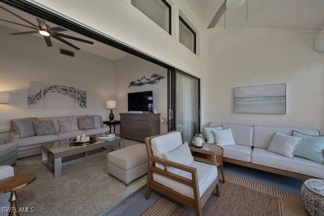 carpeted living room with beam ceiling, high vaulted ceiling, and ceiling fan