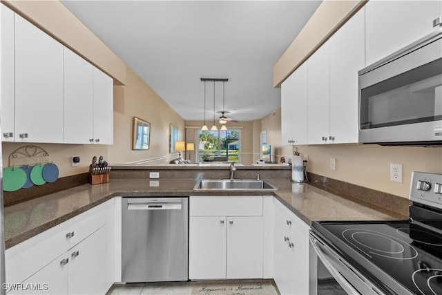 kitchen featuring sink, kitchen peninsula, ceiling fan, stainless steel appliances, and white cabinets