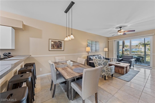 tiled dining space with ceiling fan