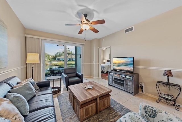 living room featuring light tile patterned floors and ceiling fan