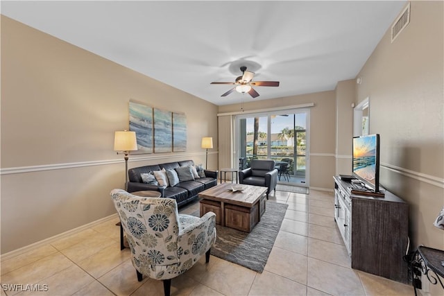 living room with ceiling fan and light tile patterned floors