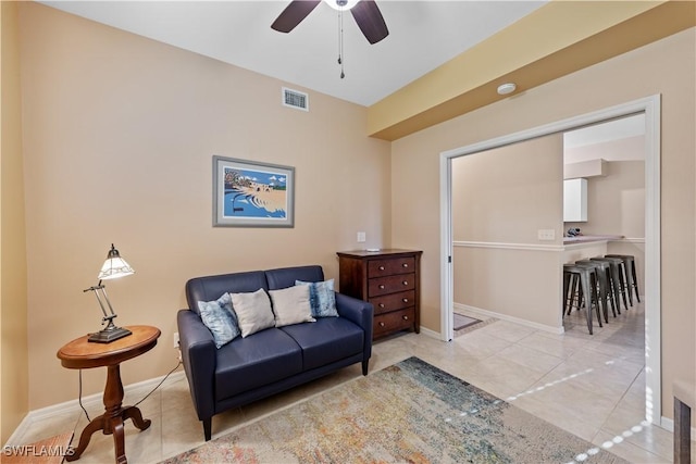 interior space with light tile patterned flooring and ceiling fan