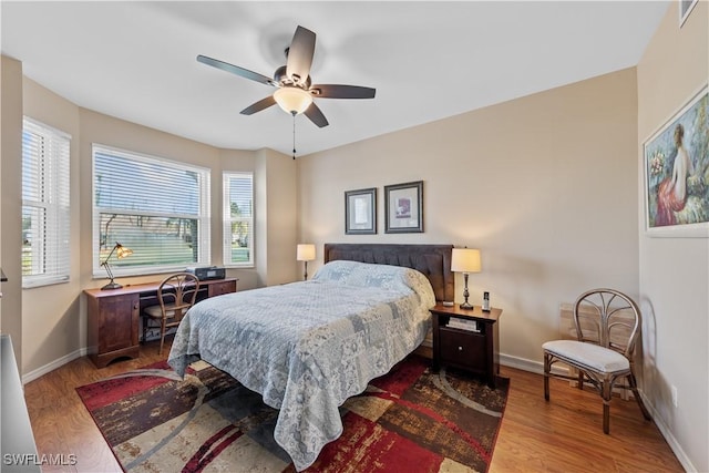 bedroom with hardwood / wood-style floors and ceiling fan