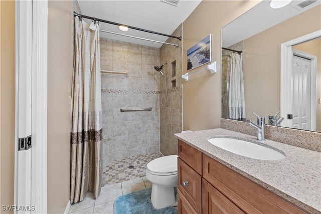 bathroom with vanity, a shower with shower curtain, tile patterned floors, and toilet