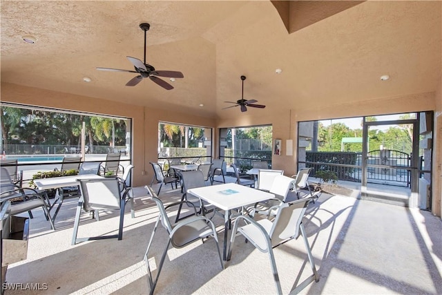 sunroom / solarium featuring a wealth of natural light and vaulted ceiling