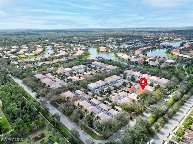 drone / aerial view featuring a residential view and a water view