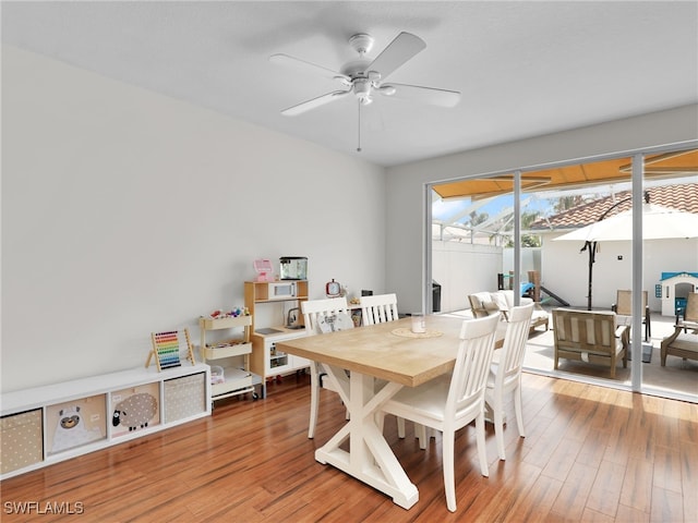 dining space featuring a ceiling fan and wood finished floors