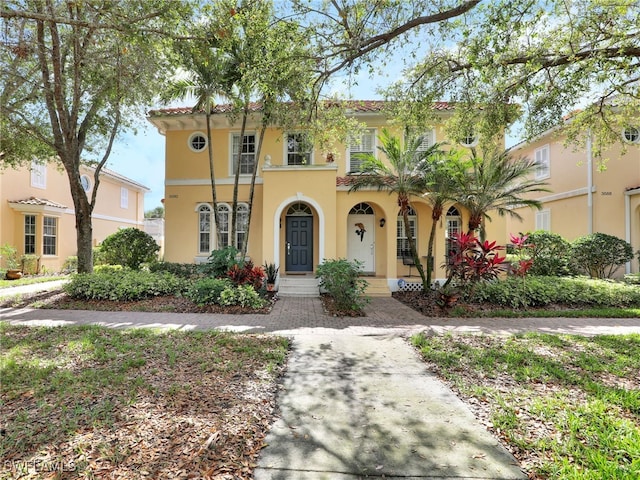 mediterranean / spanish-style home with stucco siding