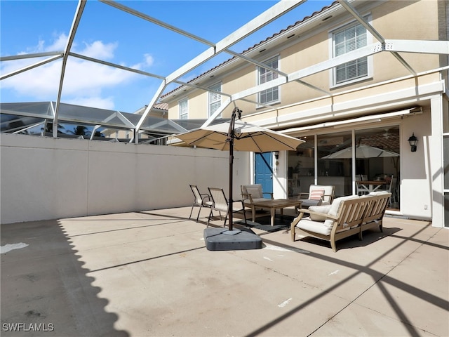 view of patio featuring a lanai, fence, and an outdoor hangout area