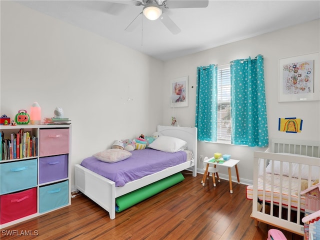 bedroom with a ceiling fan, baseboards, and dark wood-style flooring