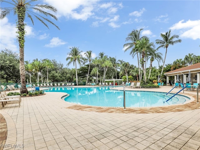 pool featuring fence and a patio