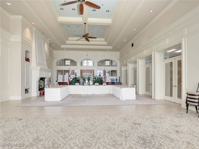 reception area featuring french doors, a fireplace, and a ceiling fan