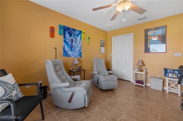 sitting room with tile patterned floors and ceiling fan