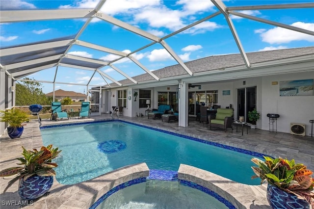 view of swimming pool featuring ceiling fan, glass enclosure, an outdoor living space, a patio area, and an in ground hot tub