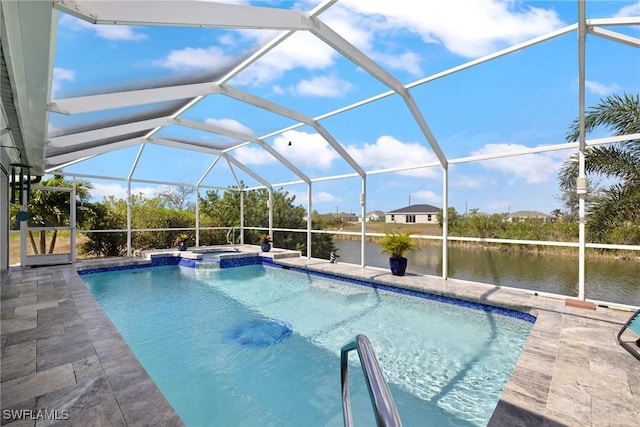 view of pool featuring an in ground hot tub, a water view, glass enclosure, and a patio area