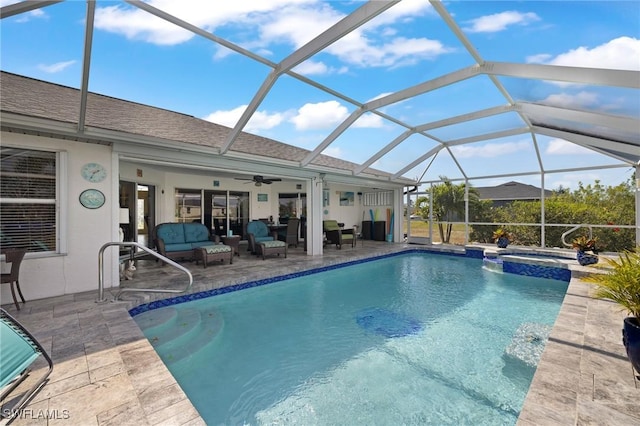 view of swimming pool featuring an in ground hot tub, an outdoor hangout area, ceiling fan, glass enclosure, and a patio area