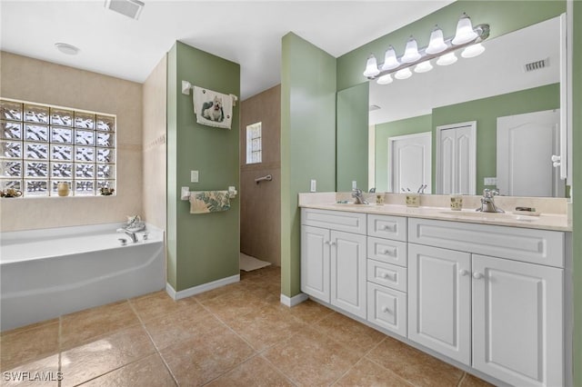 bathroom featuring tile patterned floors, vanity, and plus walk in shower