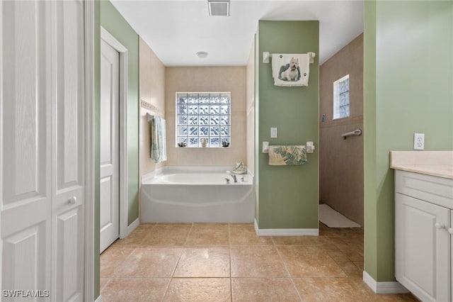 bathroom featuring vanity, tile patterned flooring, plenty of natural light, and independent shower and bath