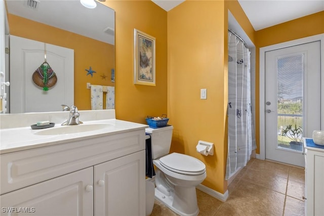 bathroom featuring vanity, tile patterned floors, toilet, and walk in shower