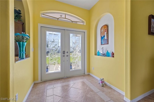 doorway with french doors and light tile patterned floors