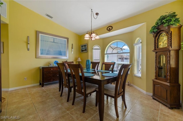 tiled dining space featuring a notable chandelier