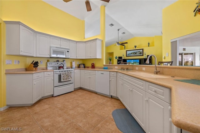 kitchen with white cabinetry, white appliances, kitchen peninsula, and sink