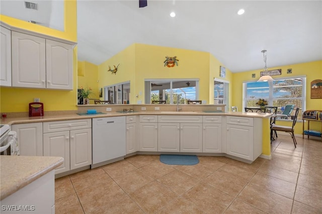 kitchen featuring sink, white cabinetry, hanging light fixtures, light tile patterned floors, and dishwasher