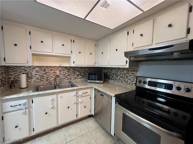 kitchen featuring stainless steel appliances, sink, decorative backsplash, and white cabinets