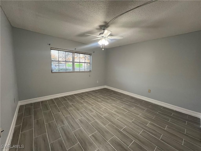 empty room with a textured ceiling and ceiling fan