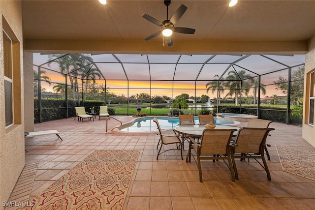 view of patio with a ceiling fan, a lanai, and a pool with connected hot tub