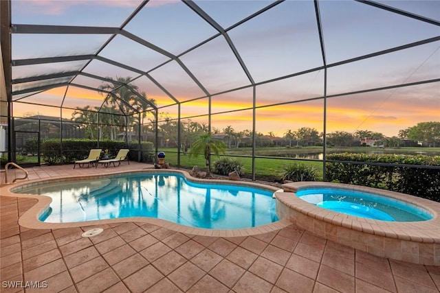 pool at dusk with a pool with connected hot tub, glass enclosure, and a patio