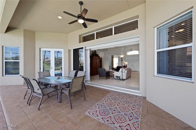 view of patio / terrace with french doors, outdoor dining space, and a ceiling fan