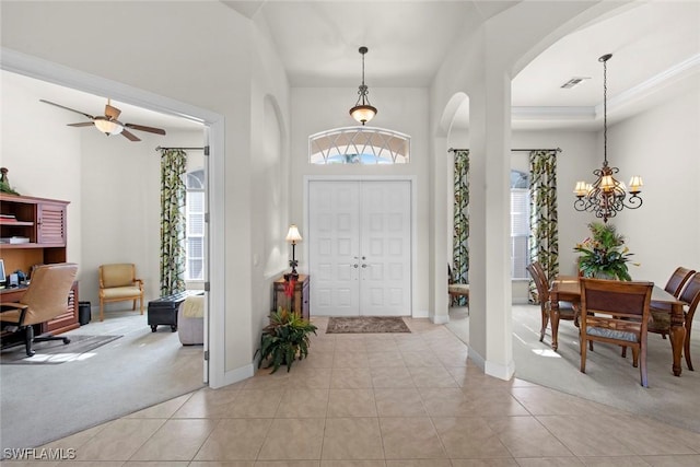 entryway featuring light carpet, light tile patterned floors, and a healthy amount of sunlight