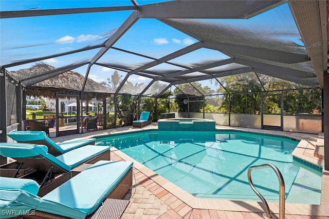 view of pool with a patio, a lanai, and a pool with connected hot tub