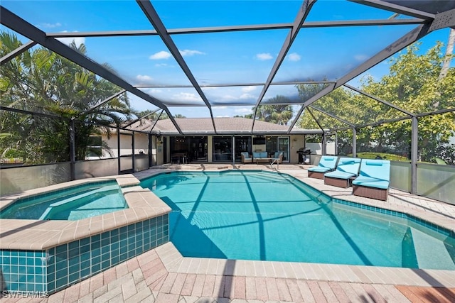 outdoor pool with a lanai, a patio, and an in ground hot tub